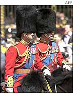 Prince Charles (L) and the Duke of Edinburgh travel behind Queen on horseback