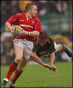 Wales wing Rhys Williams dodges Bob Skinstad's tap-tackle