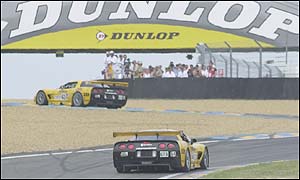 Ron Fellows and team-mate Andy Pilgrim drive under the Dunlop Bridge