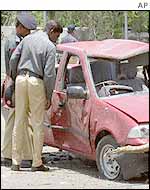 Security officials at the Karachi bomb site