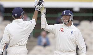 Michael Vaughan and Marcus Trescothick cut through the Sri Lankan attack in the Old Trafford gloom