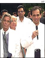 Dr Akhmal Taher, centre, part of a team of government doctors, speaks to reporters after examining Suharto