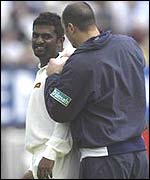 Muralitharan is attended to by the physio