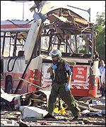 An Israeli soldier at the bomb scene