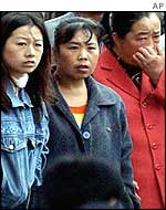 Relatives and friends of the miners wait for information in Jixi