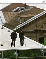 Canadian police officers atop an office tower as part of security operations for the G7 finance ministers meeting in Halifax, Nova Scotia