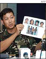 Major General Ernesto Carolina holds a picture of the rebels captured