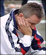 A fan sits dejected in Trafalgar Square