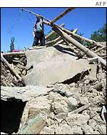 Man stands on top of his ruined home in Changireh