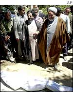 Interior Minister Abdolvahed Musavi-Lari (c) visits a destroyed village