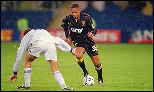 Lionel Morgan (right) takes on a Wigan defender