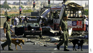 Israeli police check the wreckage of a bus in Jerusalem on 18 June following a suicide bombing