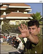 Israeli soldier with Palestinian detainees