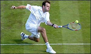 Britain's Greg Rusedski reaches for the ball