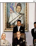 Deputy PM Abdullah Ahmad Badawi under a portrait of Dr Mahathir