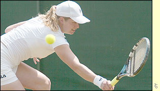Kim Clijsters hits a backhand to her opponent Samantha Reeves