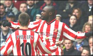 Patrick Mboma celebrates his debut goal