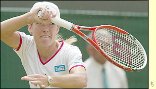 Justine Henin delivers a powerful forehand smash