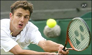 Mario Ancic of Croatia reaches for a shot from Switzerland's Roger Federer