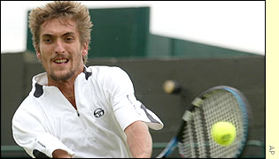 Frenchman Nicolas Escude plays a return to Britain's Alex Bogdanovic