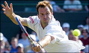Greg Rusedski plays a backhand volley at the net