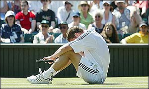 Number two seed Safin sits dejected on the court after his dramatic loss
