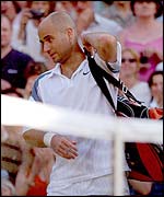 Andre Agassi walks off centre court after being knocked out of Wimbledon