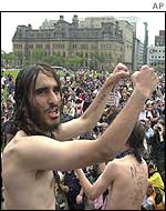 Nude protesters lead a chant on the steps of parliament in Ottawa