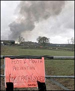 A pyre burns as the public are banned from entering field