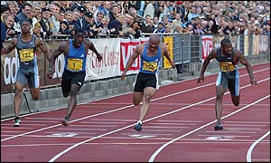 Dwain Chambers crosses the line ahead of Olympic champion Maurice Greene and Tim Montgomery to win the 100m