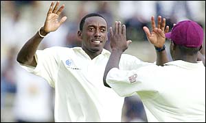 Pedro Collins celebrates with West Indies teammate Ridley Jacobs after dismissing Mark Richardson