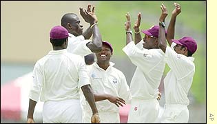 Cameron Cuffy celebrates with his West Indies teammates after bowling Lou Vincent early in the match
