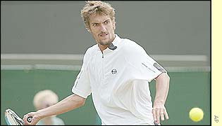 Nicolas Escude plays a baseline forehand