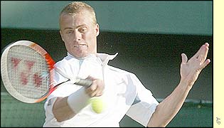 Lleyton Hewitt plays a game-winning forehand