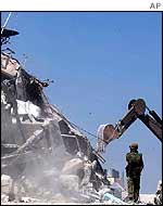 A digger sorting debris in Hebron