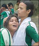 Children cry as their school shuts down