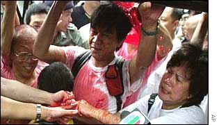 A pro-democracy activist sprays police with fake blood