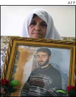 Muhanad al-Taher's mother with a portrait of her son