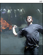 Palestinian man throws missile at Israeli soldiers