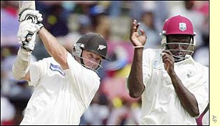 Mark Richardson smashes the ball to the boundary 