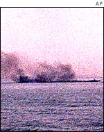 Smoke pours from a patrol ship after the battle