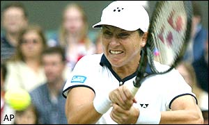 Monica Seles grimaces as she goes for a backhand