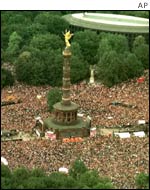 Revellers dance around Berlin's Victory monument