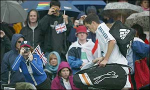 Tim Henman leaves Centre Court as more rain interrupts play