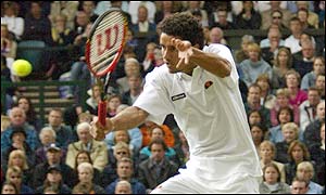 Brazil's Andre Sa plays a backhand to Tim Henman during the second game of the match