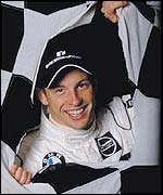 Jenson Button burst through a chequered flag