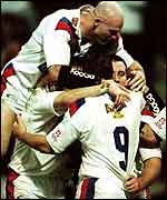 Paul Sculthorpe is mobbed by his team-mates after scoring in 2001