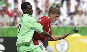 Joseph Yobo tangles with Michael Owen in the World Cup