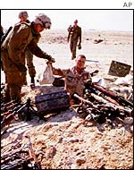 US soldiers examining Iraqi weapons cache at the end of the Gulf War