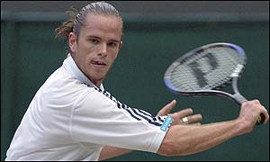 Xavier Malisse plays a backhand reply to Nalbandian